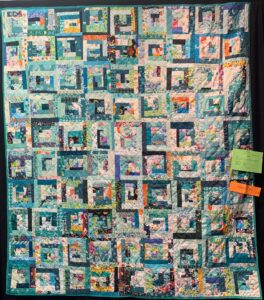 Modern scrappy log cabin in blues and teals