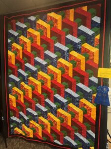 3D illusion quilt in bright colors resembling gears