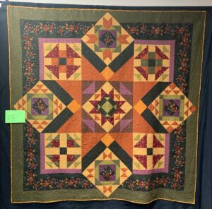 traditional quilt with pieced blocks in reproduction fabrics